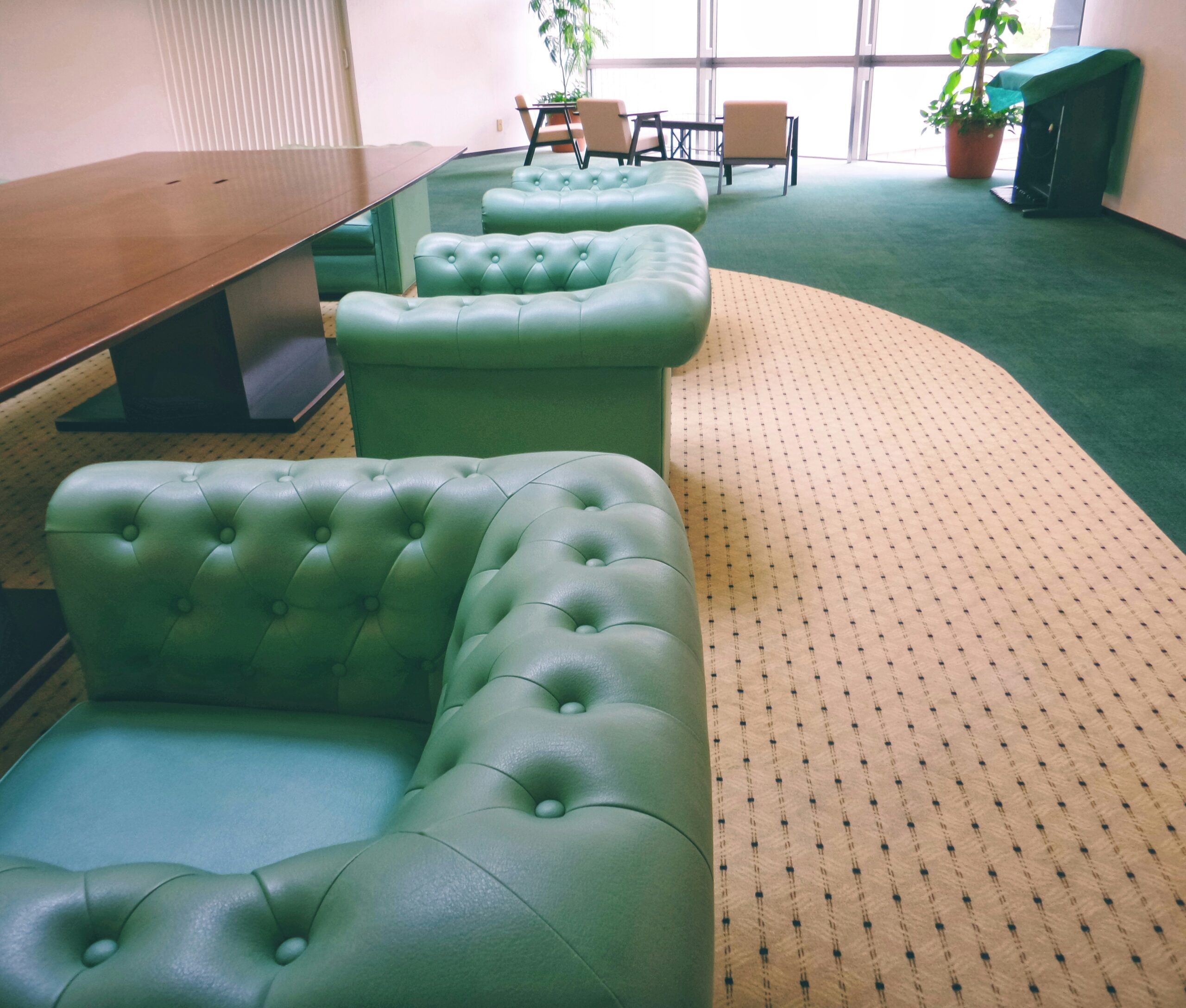 A modern airport-style lounge with leather chairs and complimentary snacks
