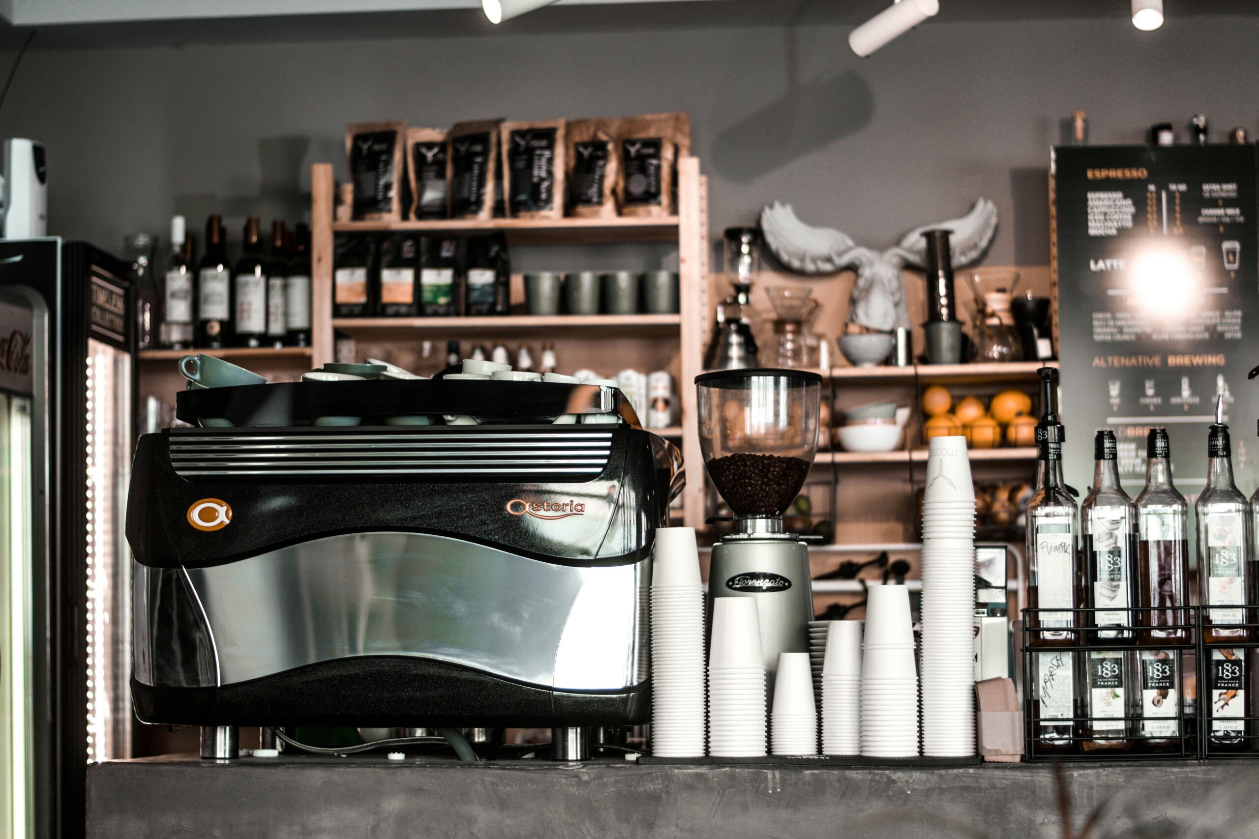 A sleek counter offering fresh coffee and pastries inside a private lounge