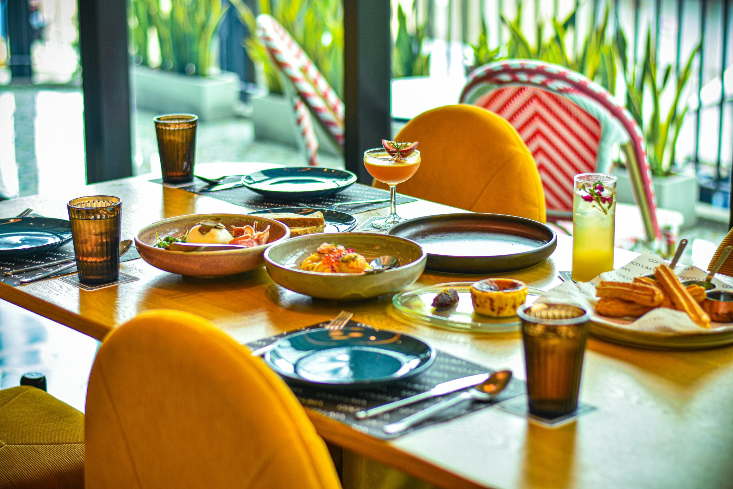 An elegant menu showcasing gourmet dishes available on a luxury bus