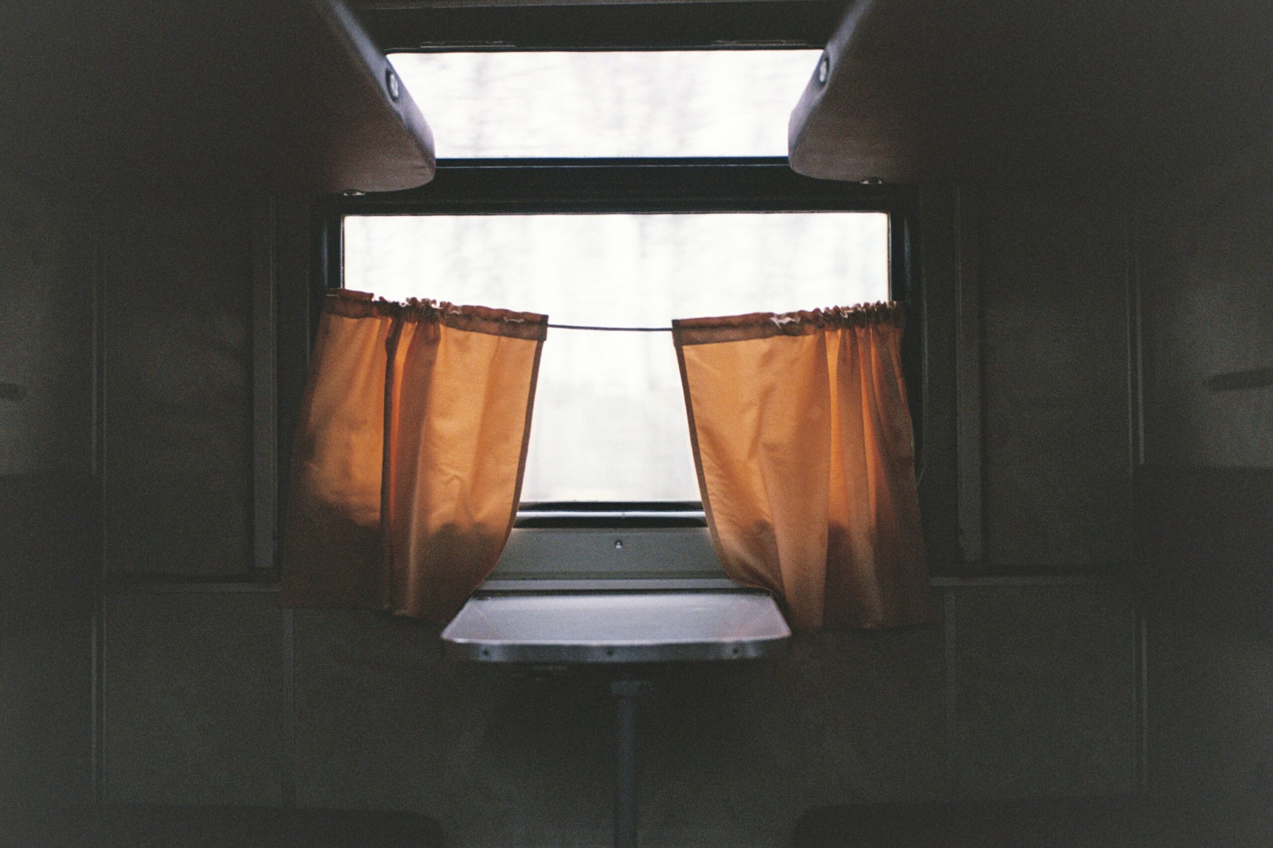 Close-up shot of a luxurious coach interior featuring leather seats and wood accents