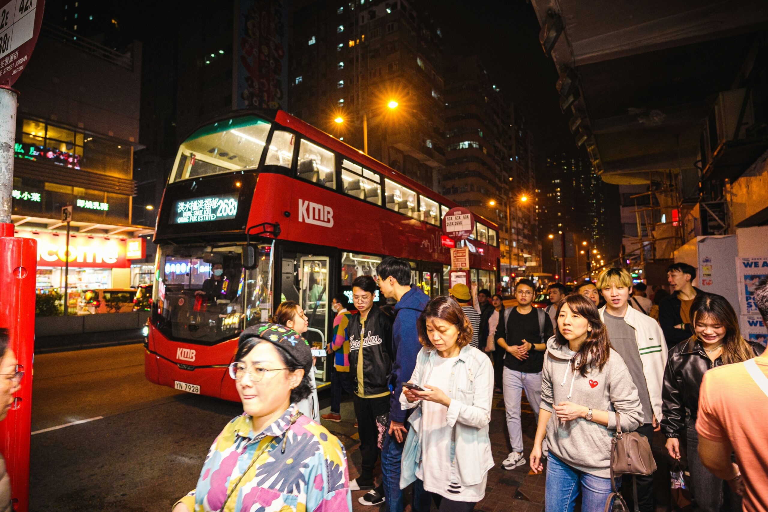 Happy tourists posing in front of their luxury bus