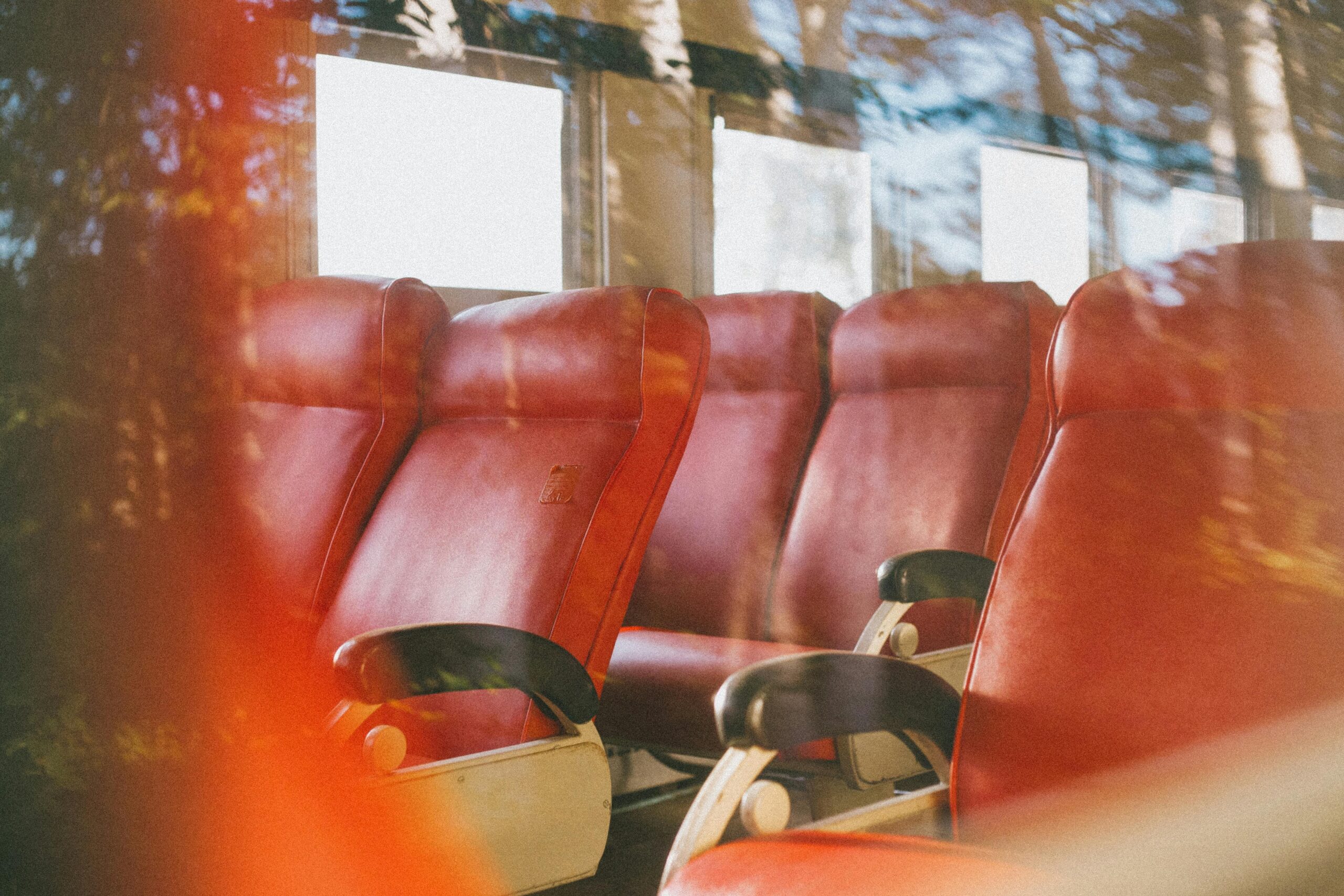 Interior of a luxury bus showcasing plush leather seating and ambient lighting