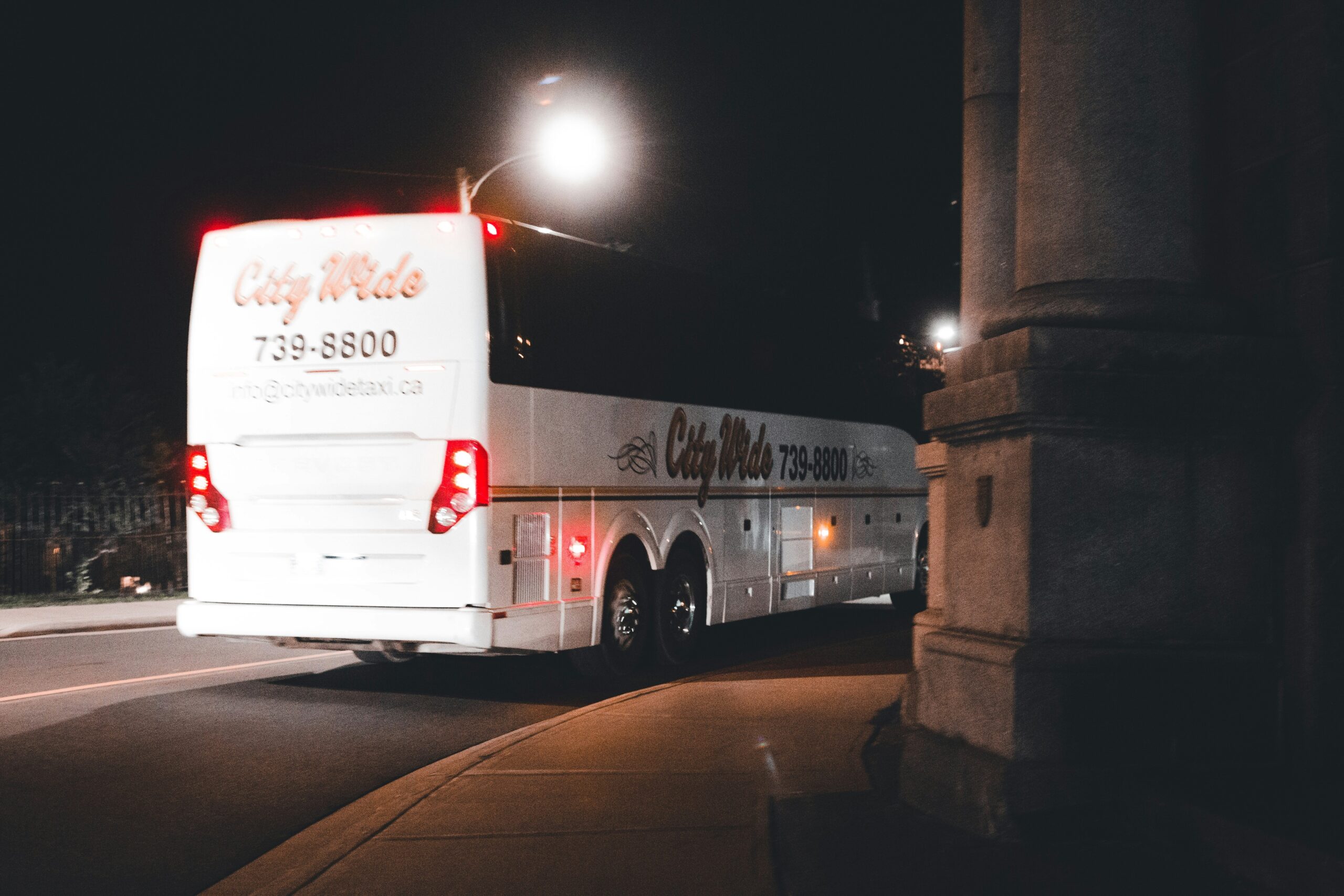 A sleek interior of a luxury bus featuring plush seating and ambient lighting