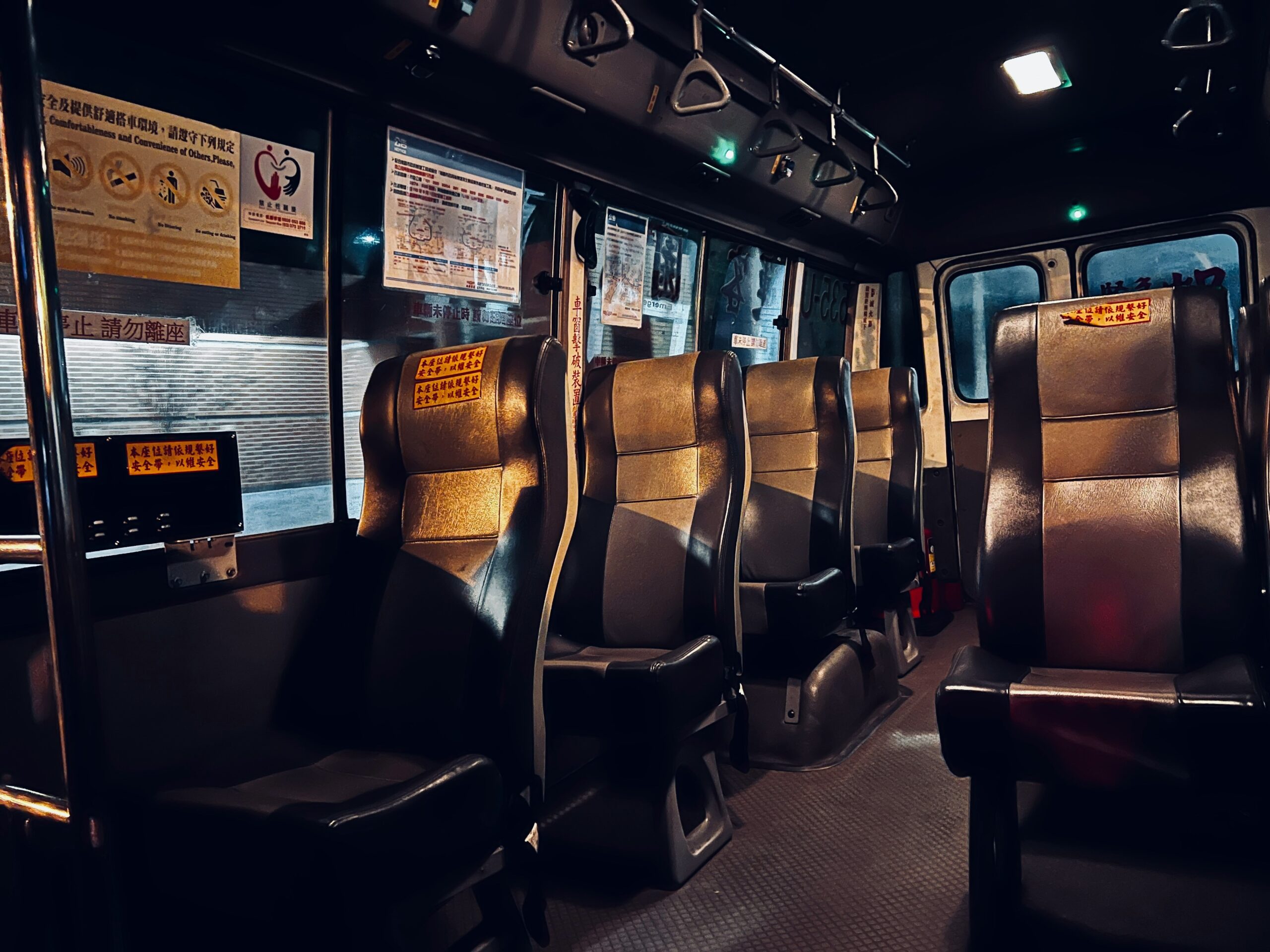 A couple enjoying wine glasses seated in luxury bus seats