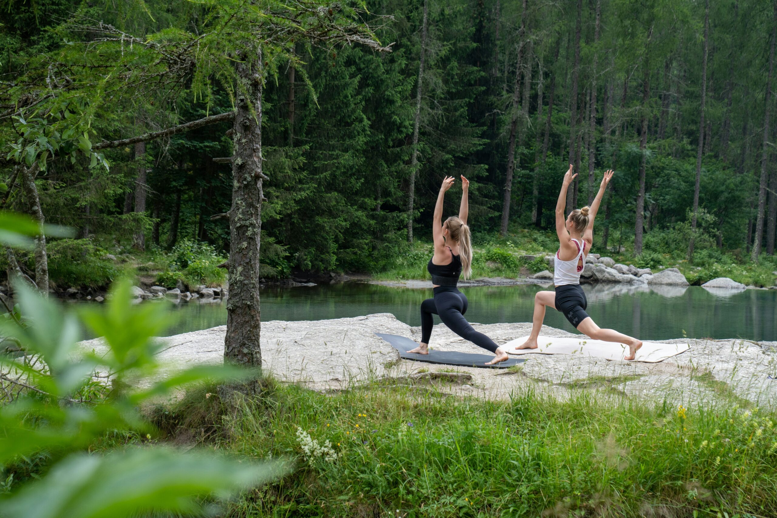 Passengers practicing yoga near scenic mountains