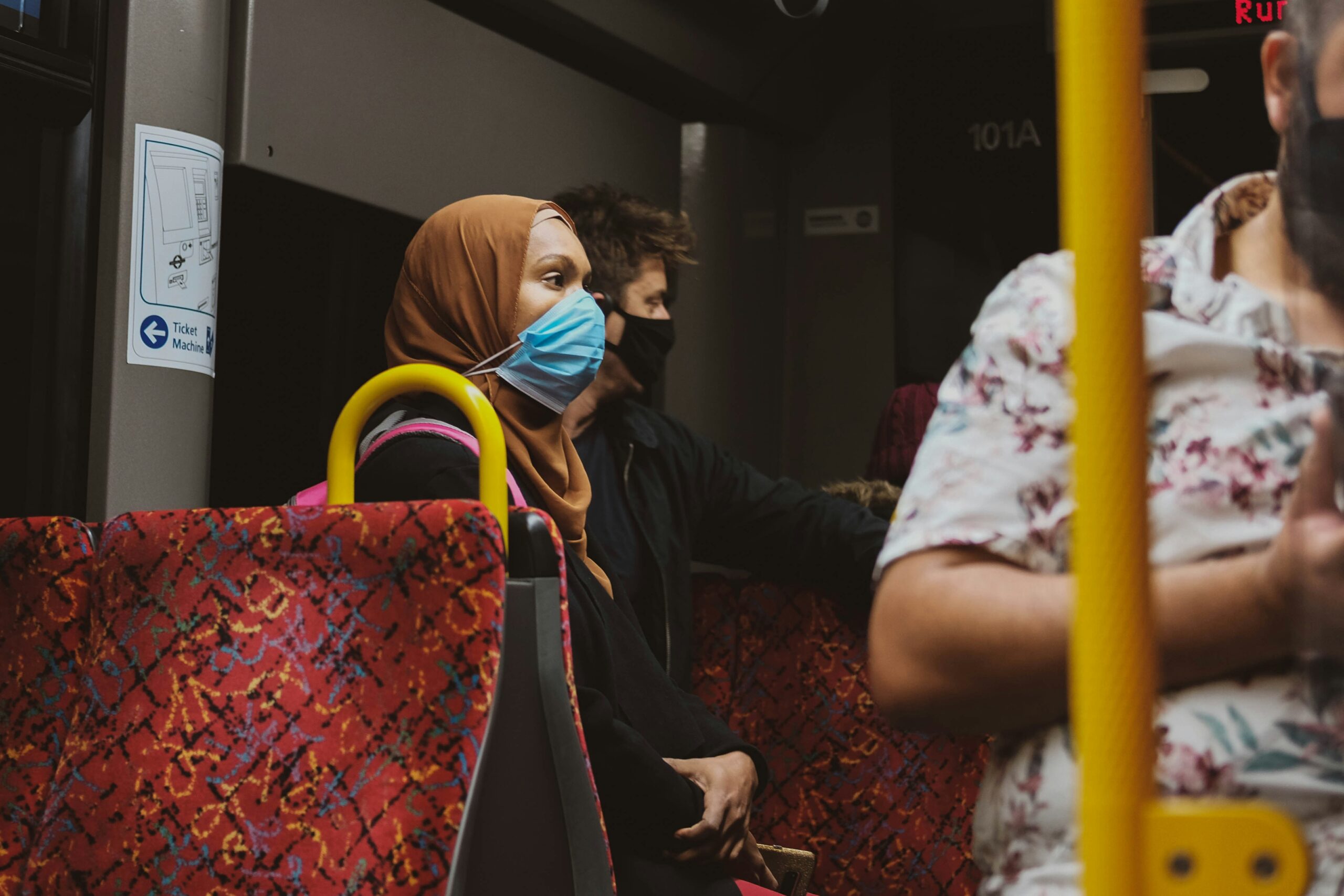 Woman smiling while using wireless charging pad on luxury bus