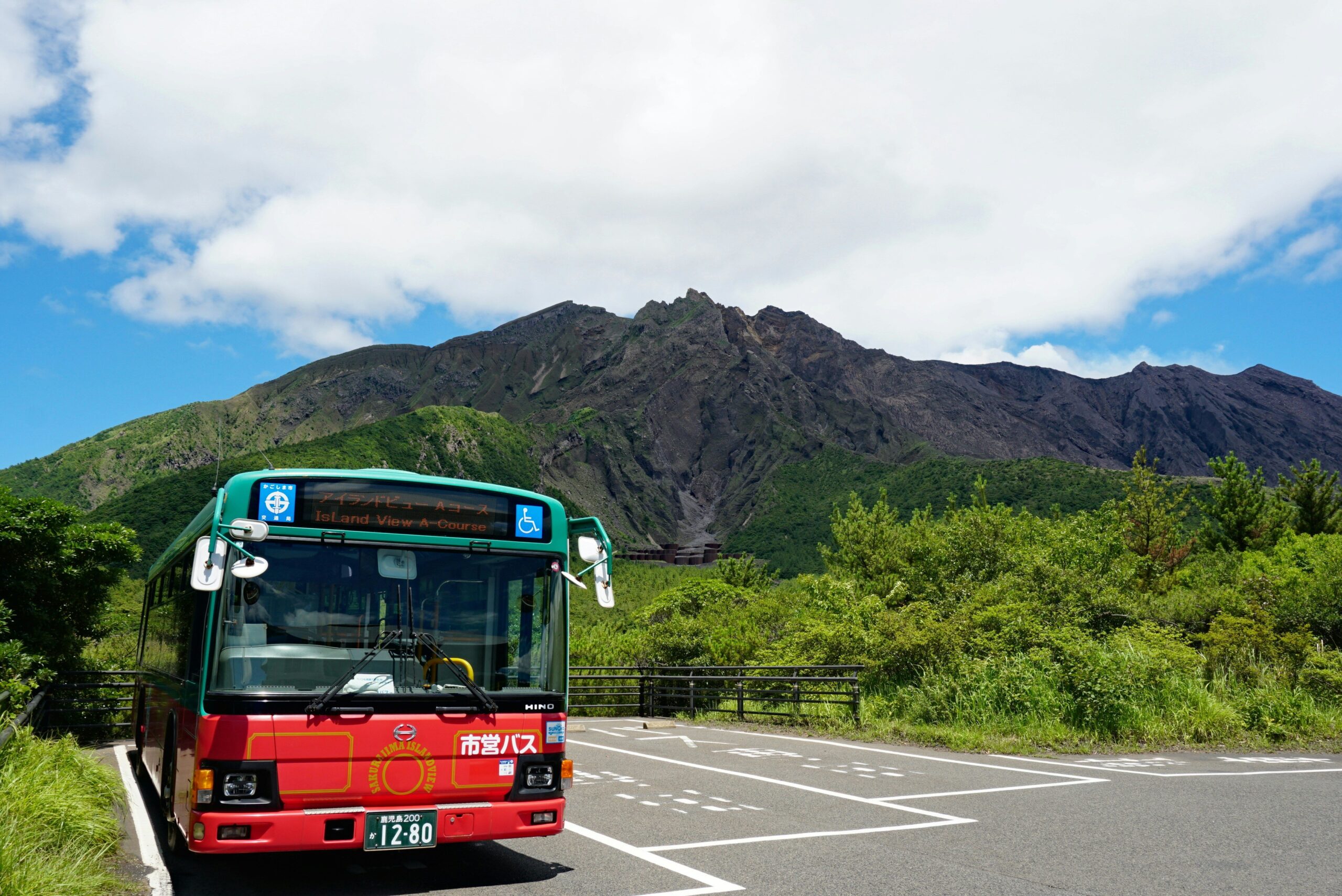 A luxury bus parked against a golden sunset backdrop