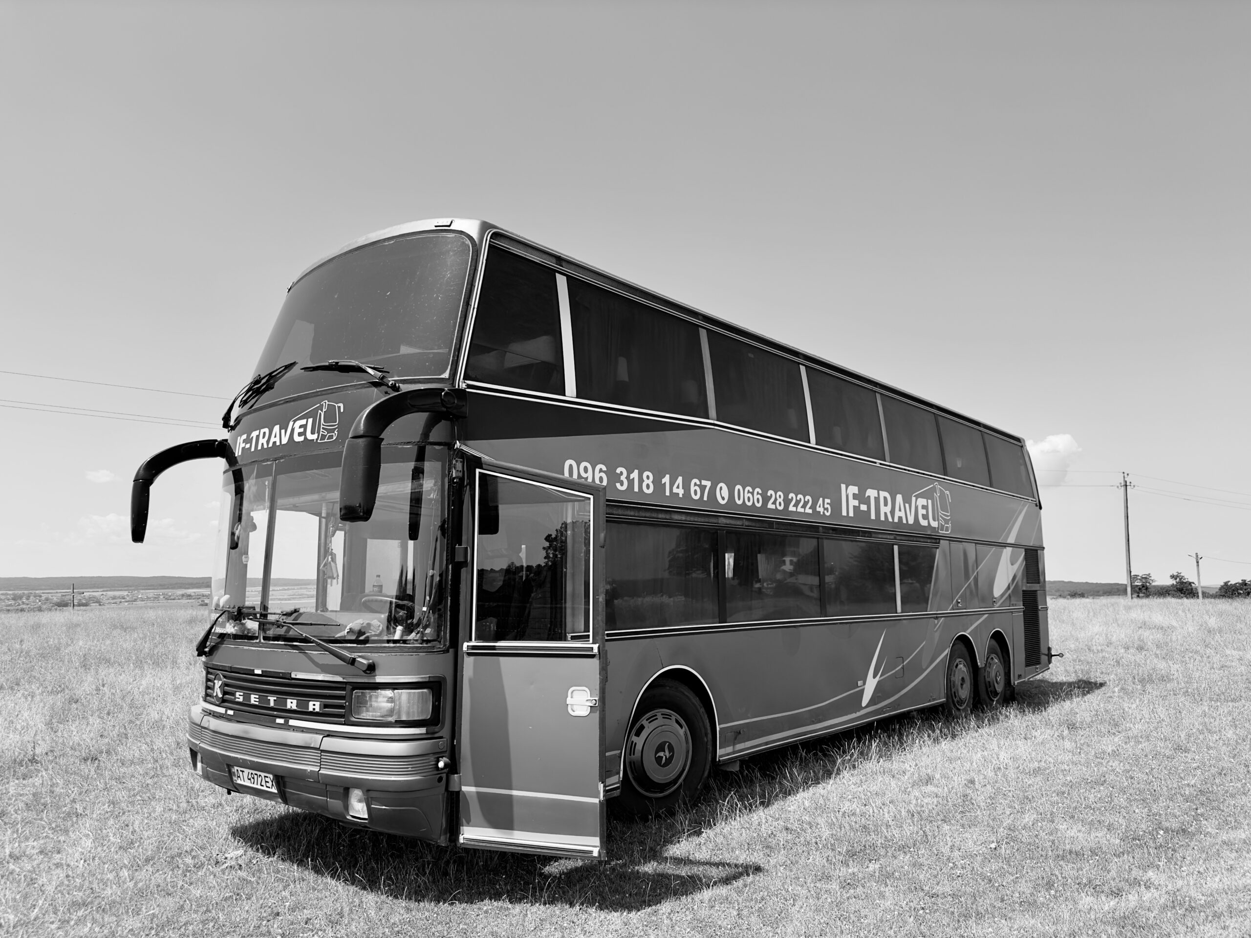Happy passengers enjoying a luxury bus tour with stunning mountain views