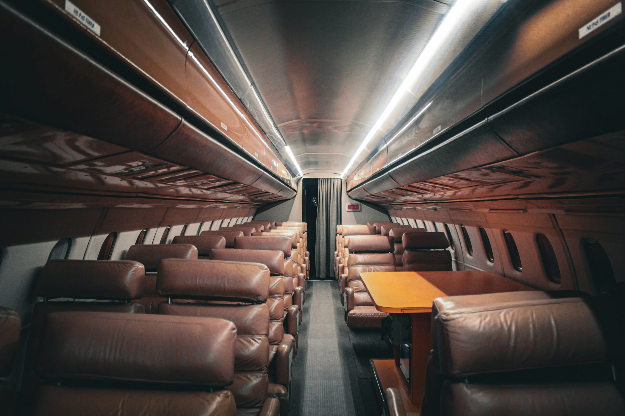 Travelers enjoying a smooth ride aboard a first-class elite bus, sipping beverages and chatting happily.