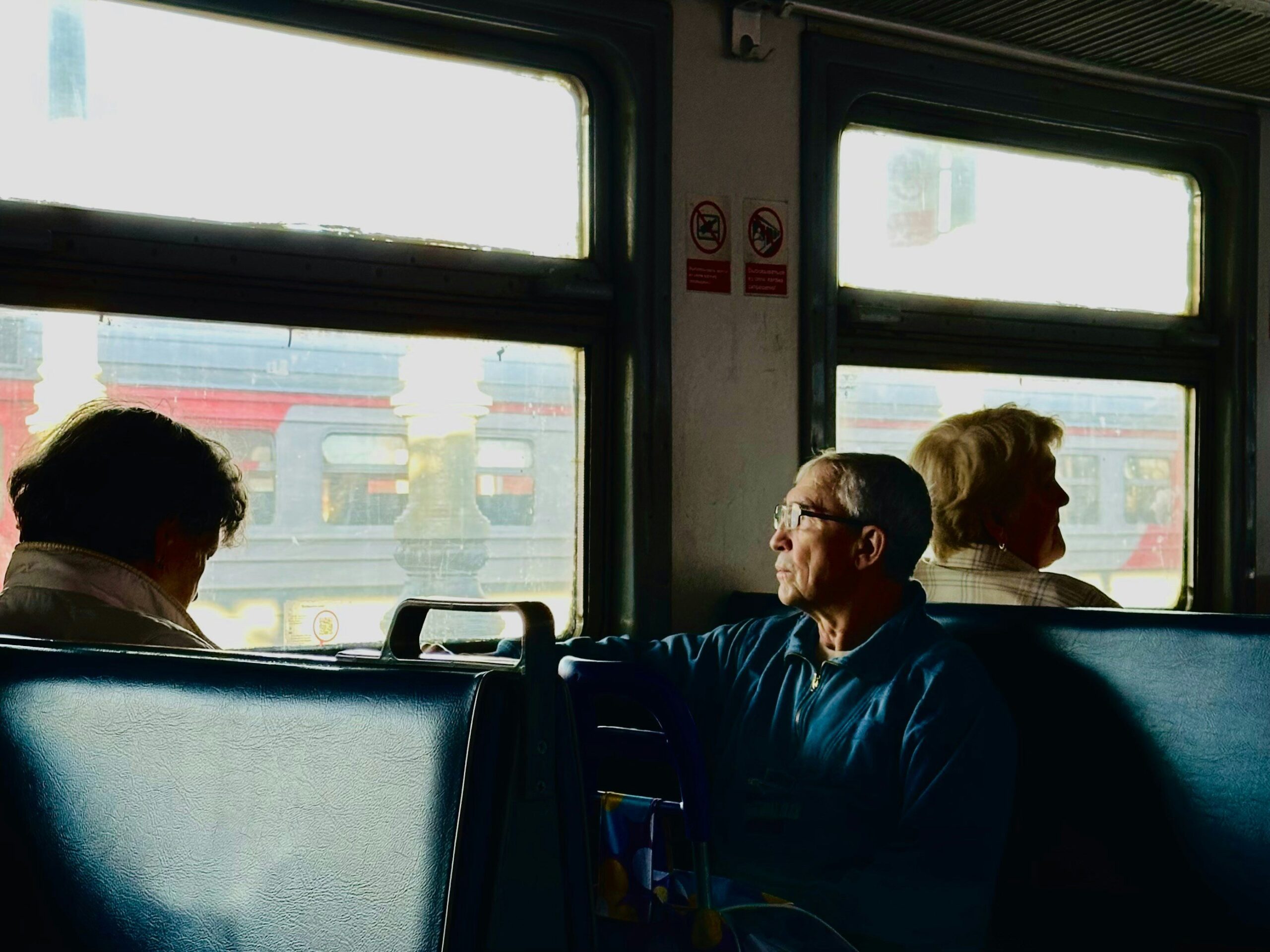 Travelers enjoying a wine tasting session aboard a luxury coach during sunset