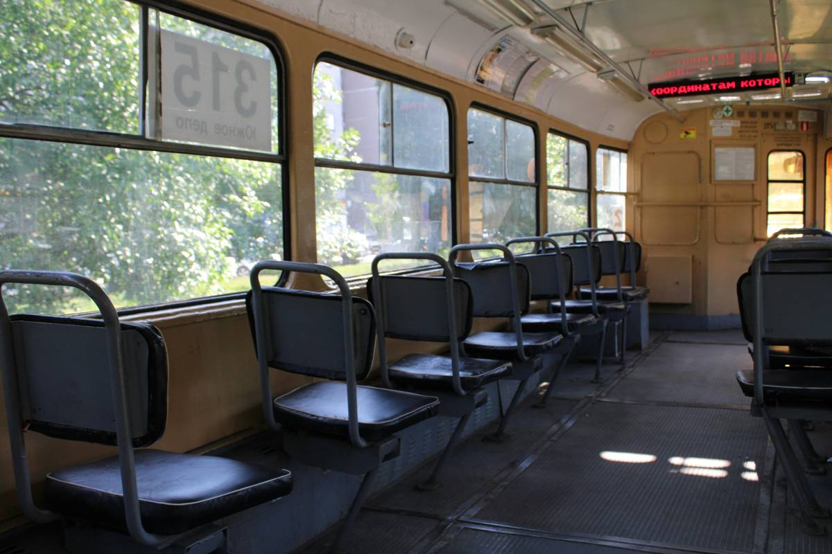 A crowded bus with uncomfortable seating and passengers looking stressed