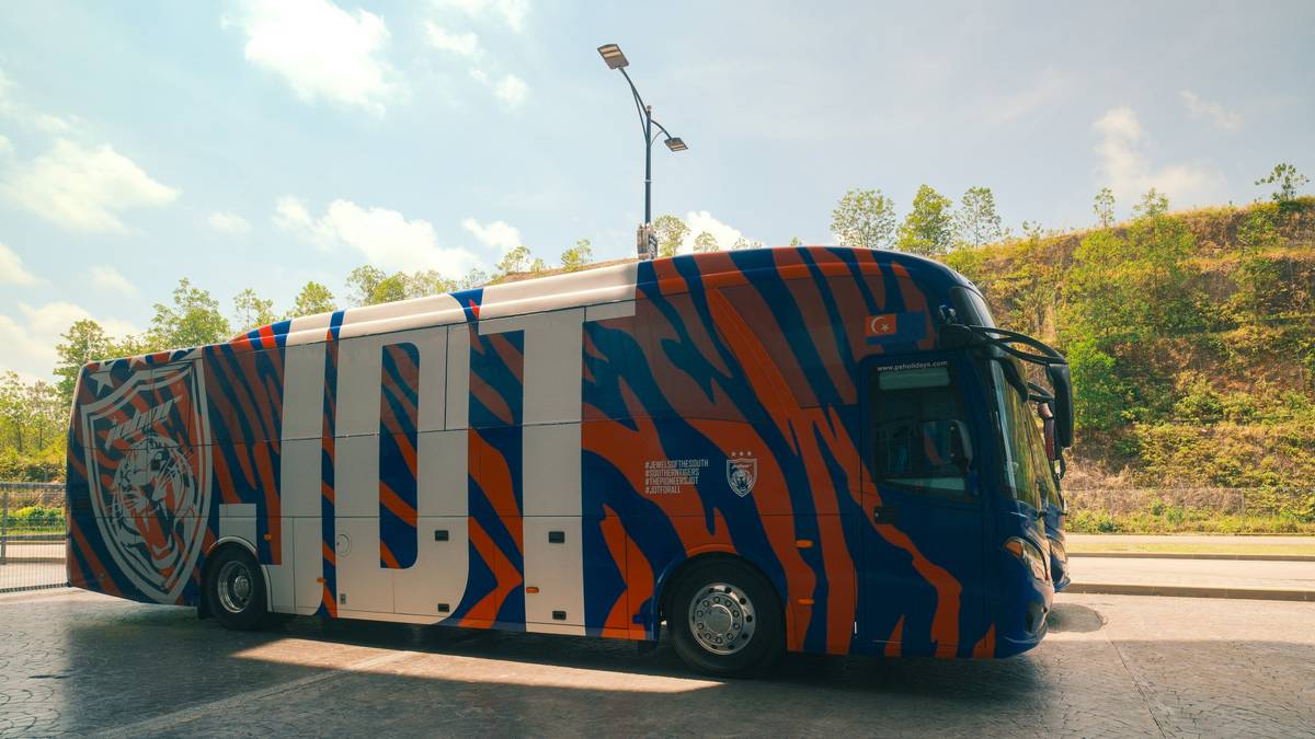 Group of travelers laughing together inside an elite sightseeing bus