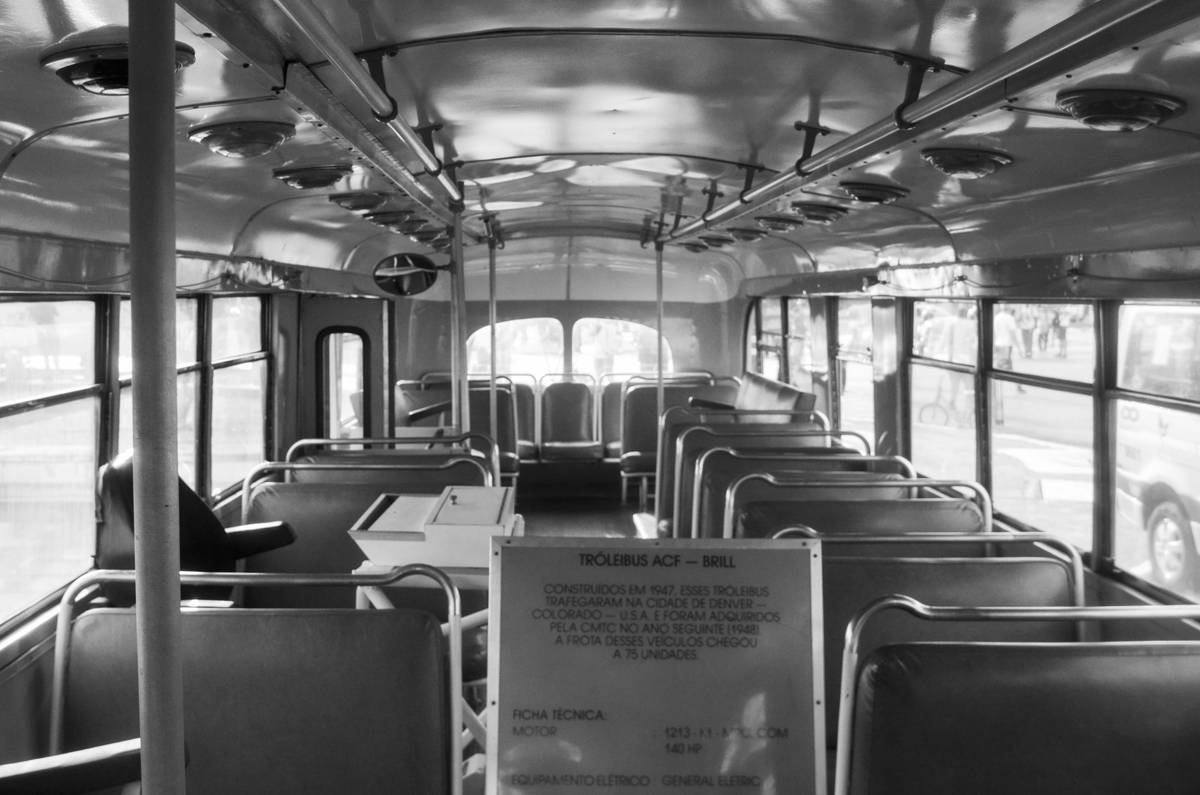 Passenger enjoying wine on a first class coach looking at scenic landscapes outside