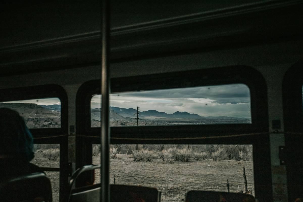 A modern luxury bus interior featuring leather seats and large windows