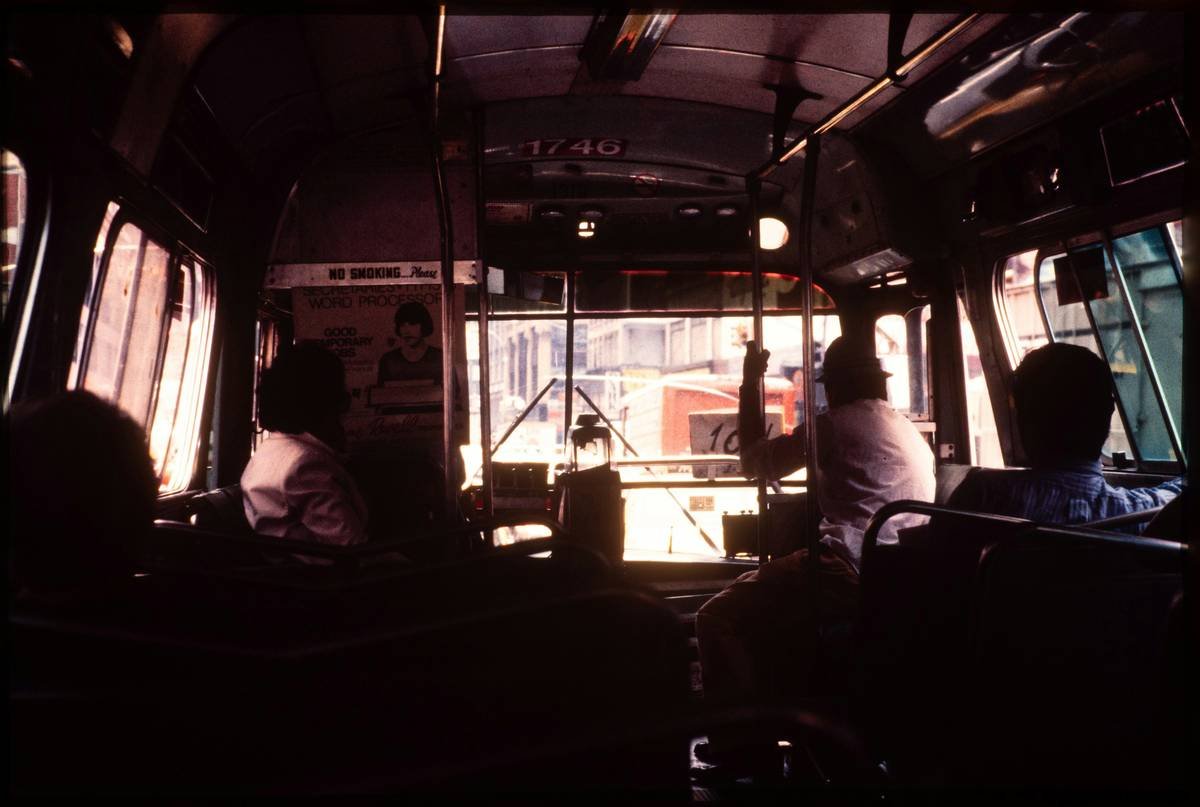 A luxurious bus interior with plush seating, ambient lighting, and a bar area.