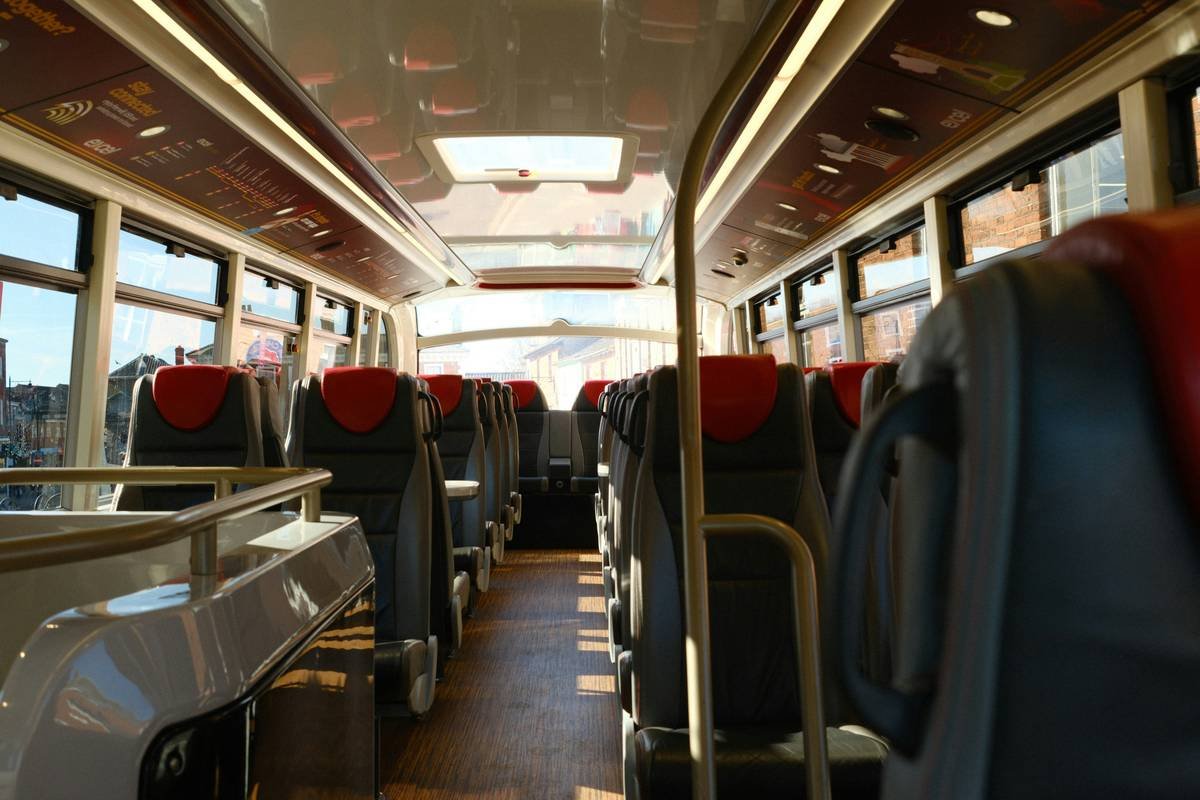 Comparison chart showing standard vs luxury coach features including legroom, amenities, and staff training