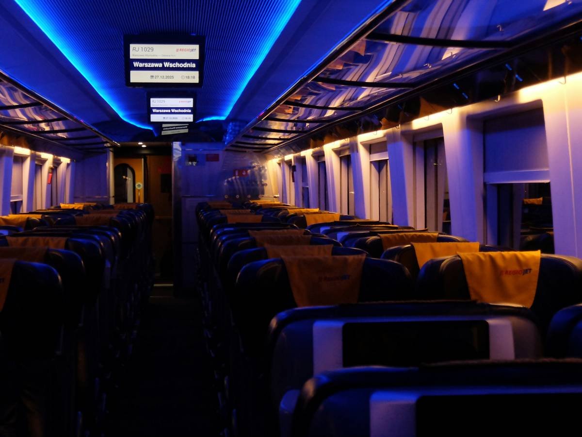 Empty train carriage with blue and yellow lighting