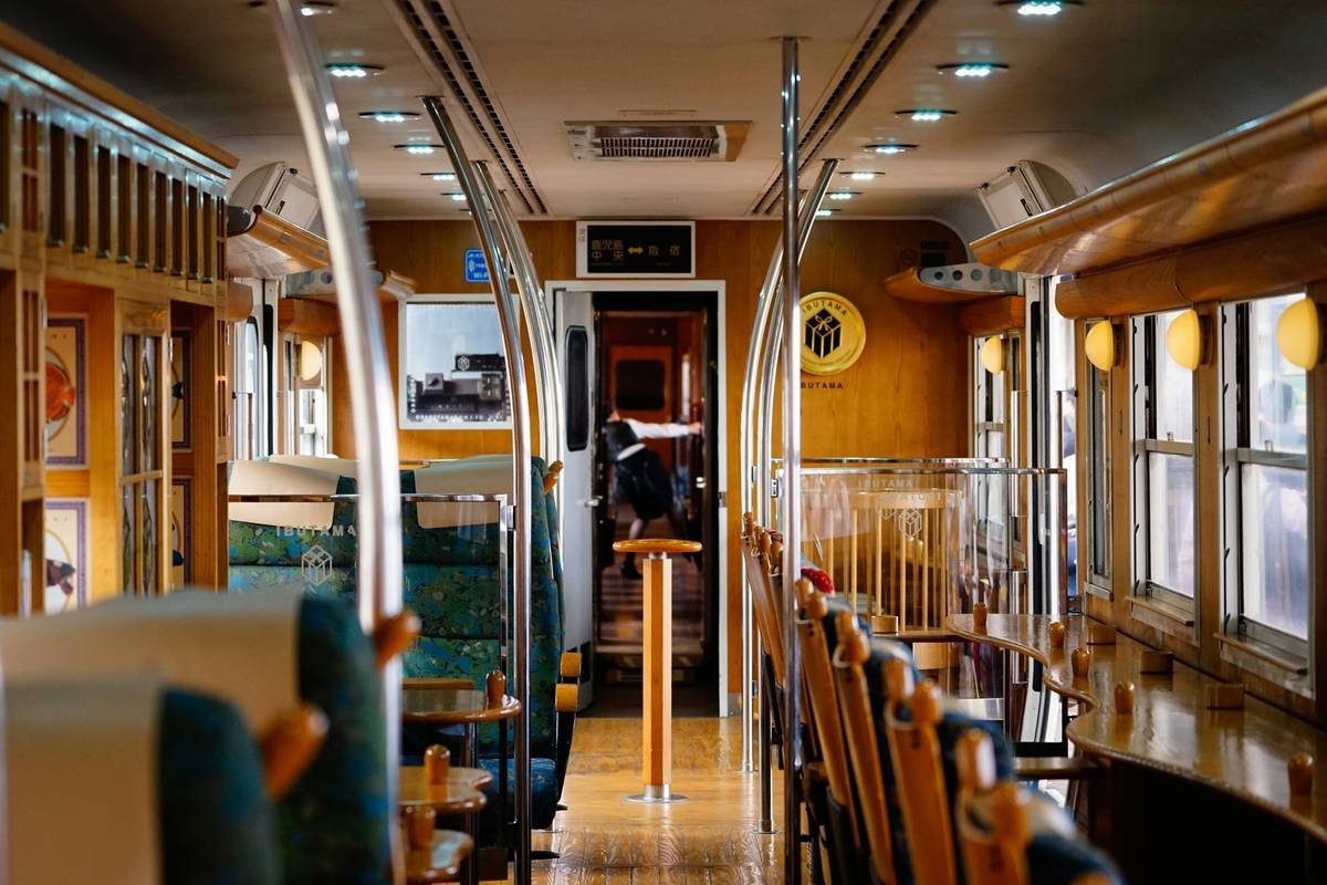 Interior of a vintage train carriage with plush seating.