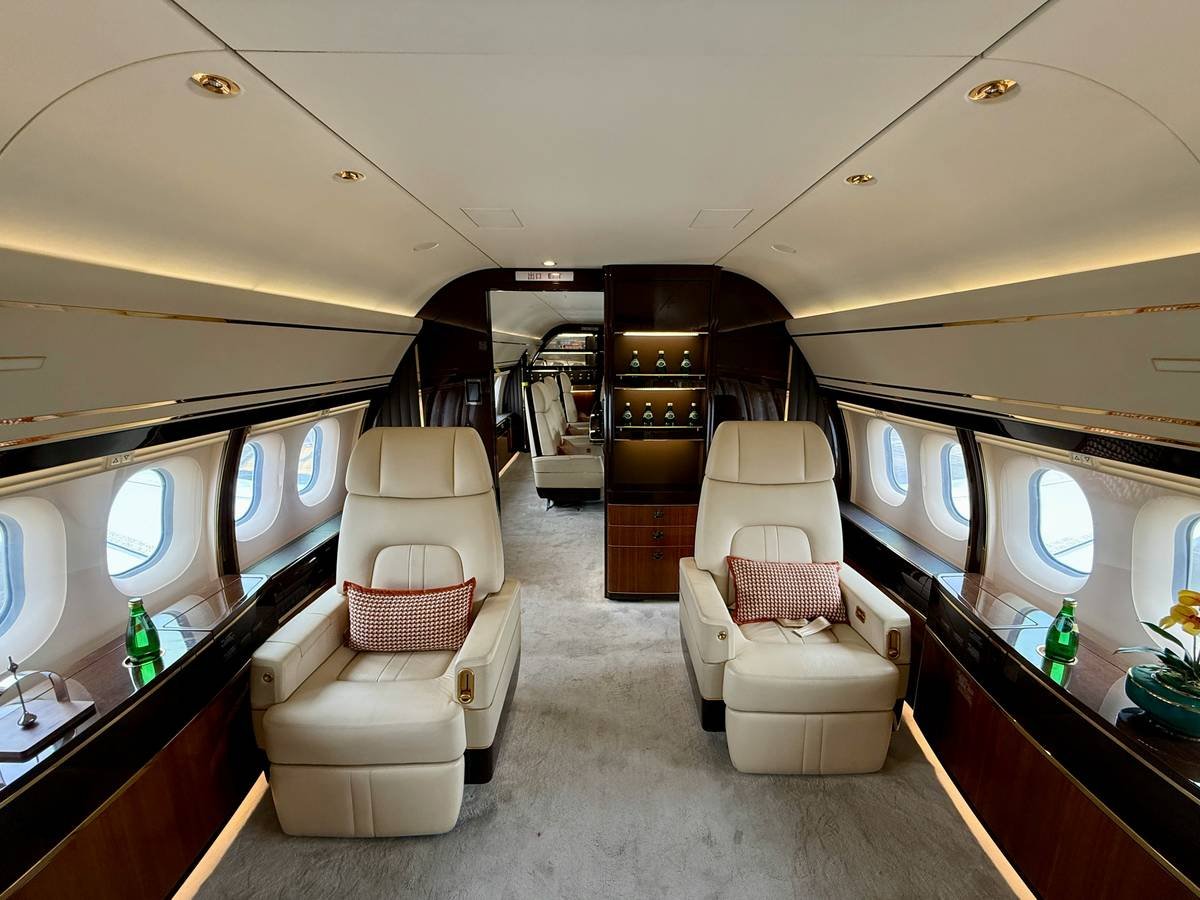 Luxurious interior of a private jet with comfortable seating.