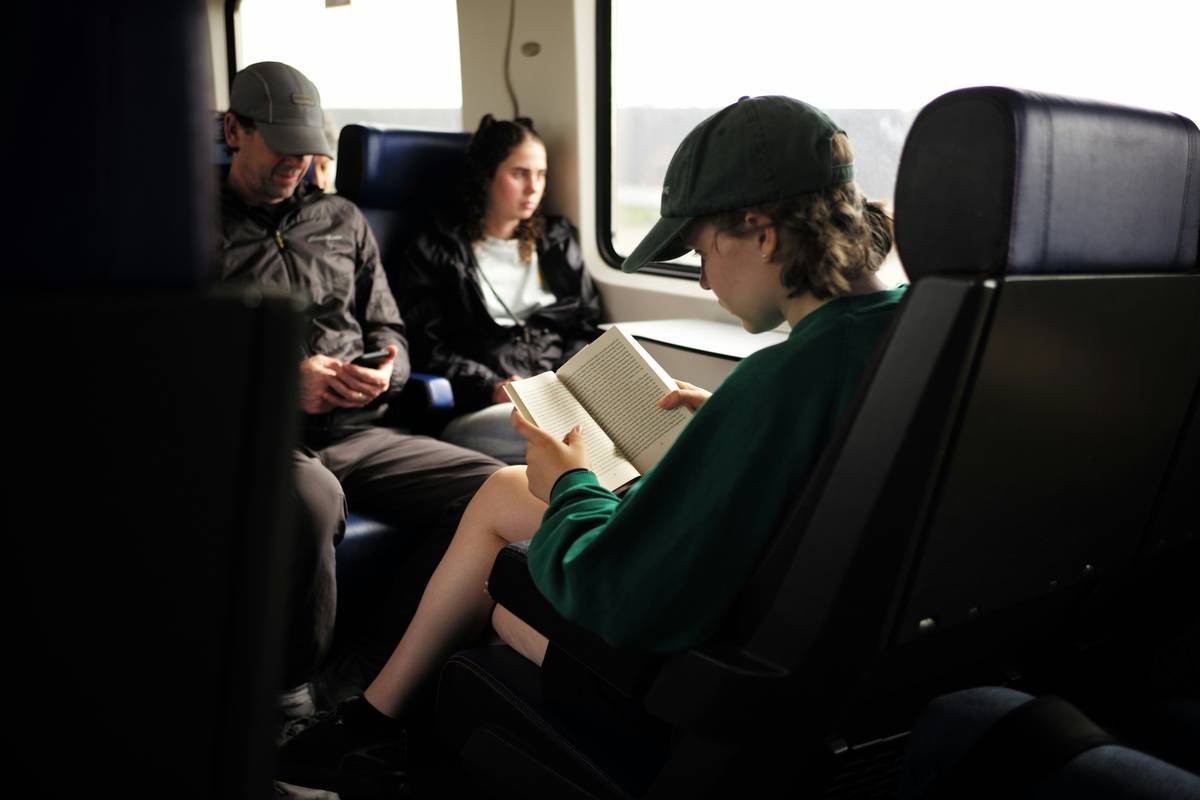 Side-by-side comparison infographic showing standard Essex coach (crowded, basic seats) vs true first class bus (leather recliners, spacious layout, refreshment service)