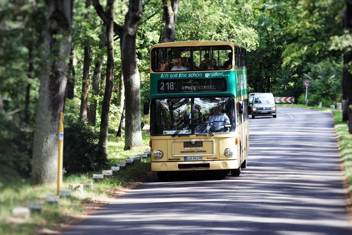 Side-by-side comparison: standard 45-seater bus vs. modern luxury coach with reclining seats, USB ports, and panoramic windows