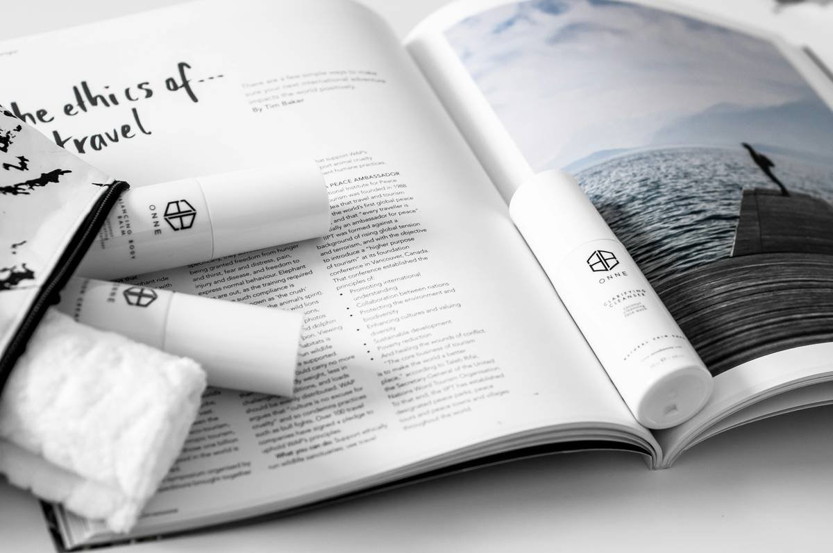 Skincare travel sizes on open magazine