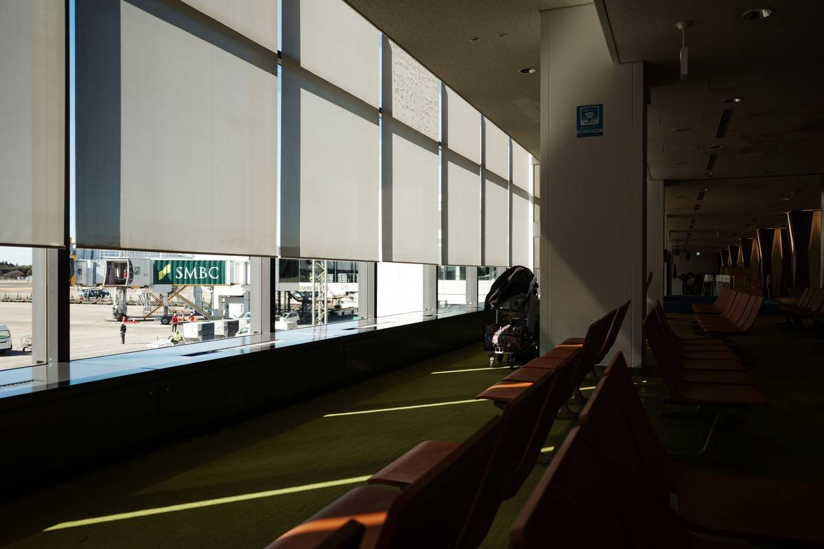 First class airport bus service arriving curb-side at major international airport terminal