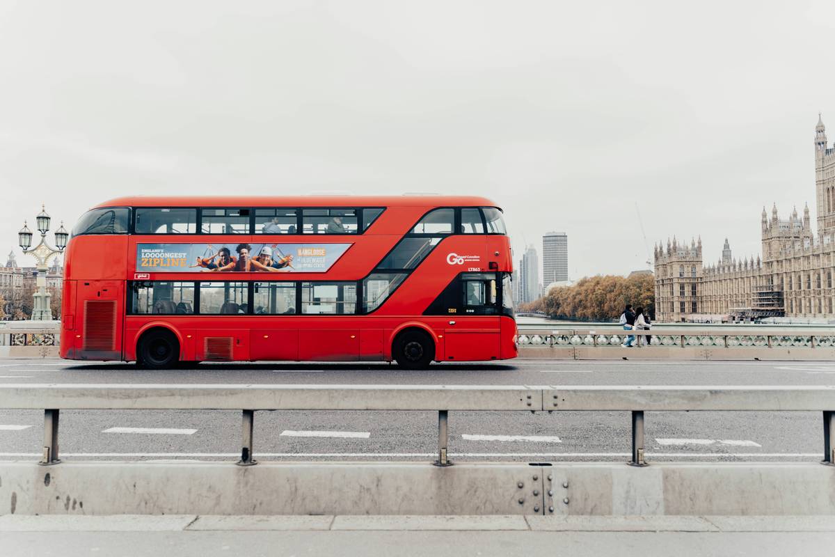 Modern luxury coach on a scenic UK countryside road, used for luxury coach trips rotherham