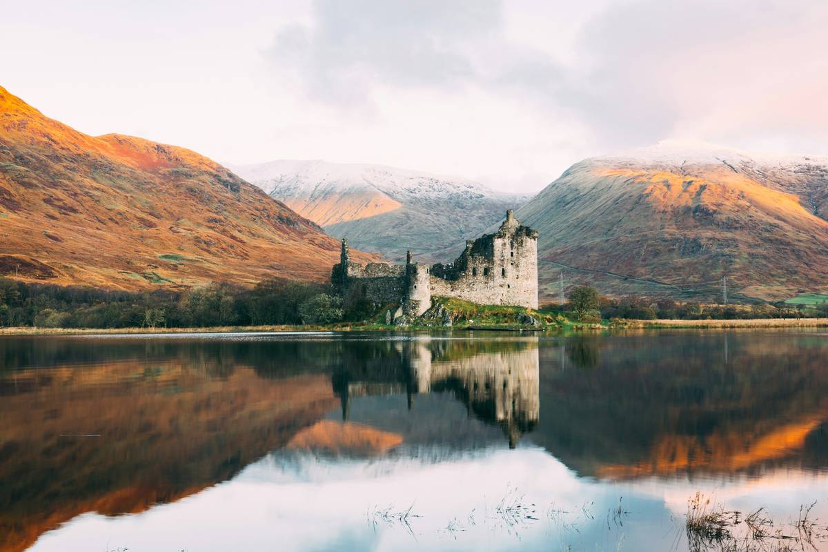 luxury coach trips scotland through misty Scottish Highlands with comfortable interior visible