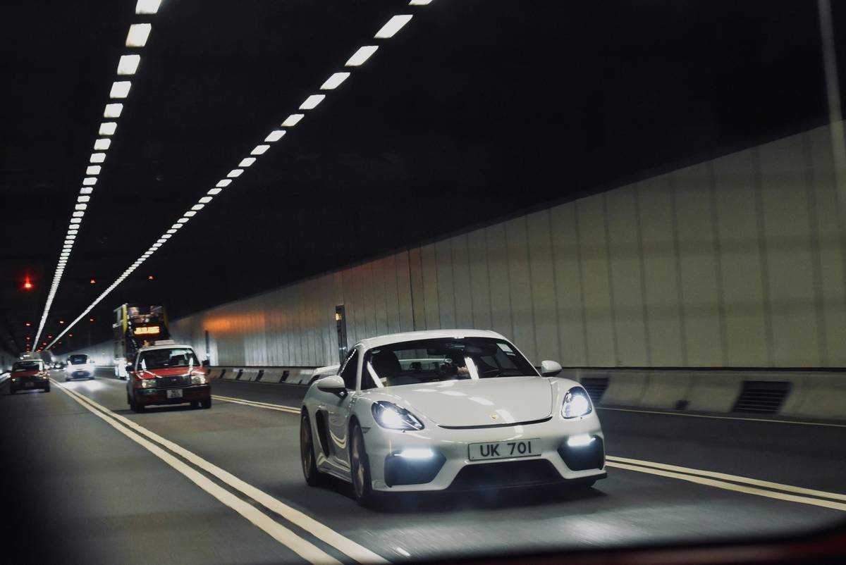 White sports car driving in a modern tunnel